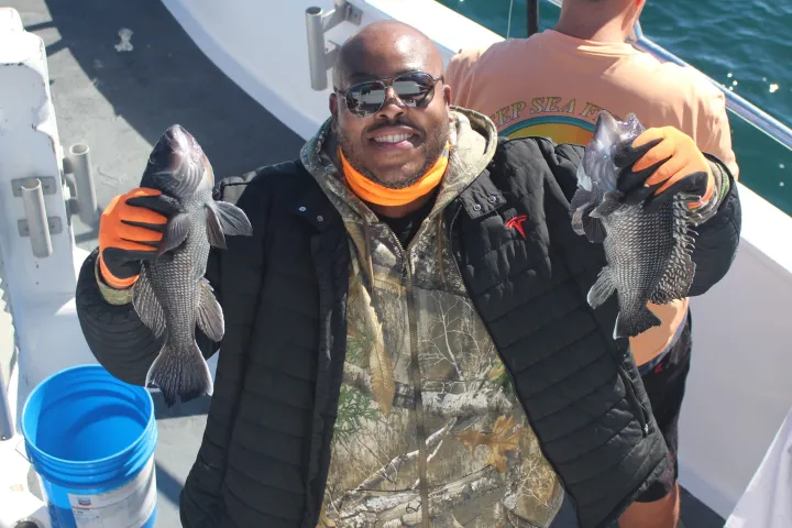 a couple of people that are standing in the water