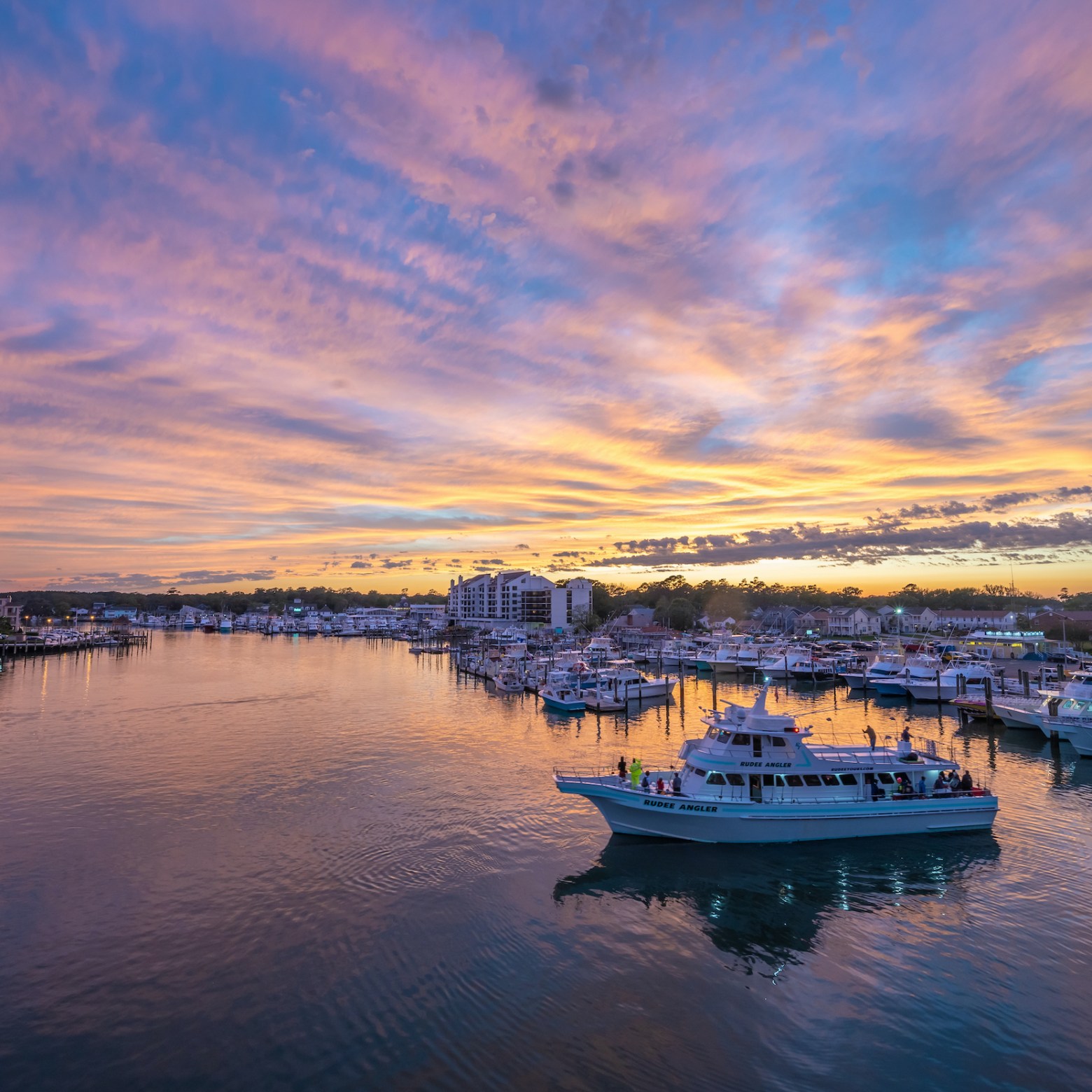 a boat traveling along a river next to a body of water