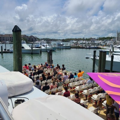 a group of people on a dock next to a body of water