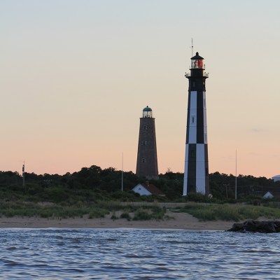 a large body of water with a city in the background