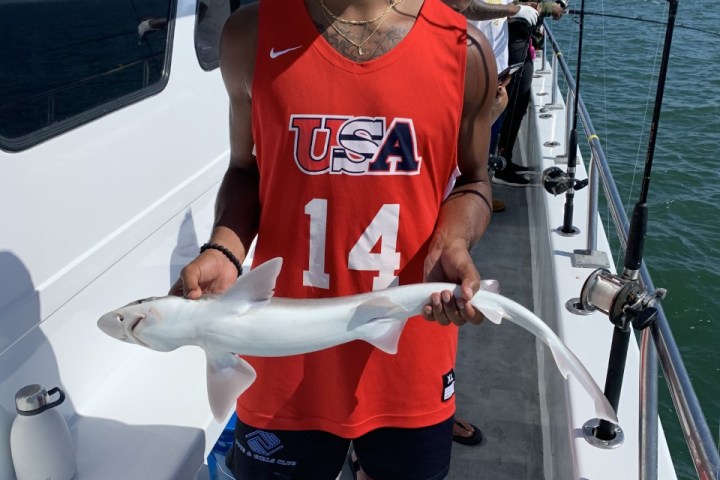 a man standing on a boat in the water
