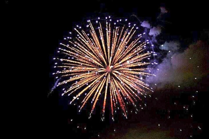 fireworks in the sky with Cosmo Clock 21 in the background