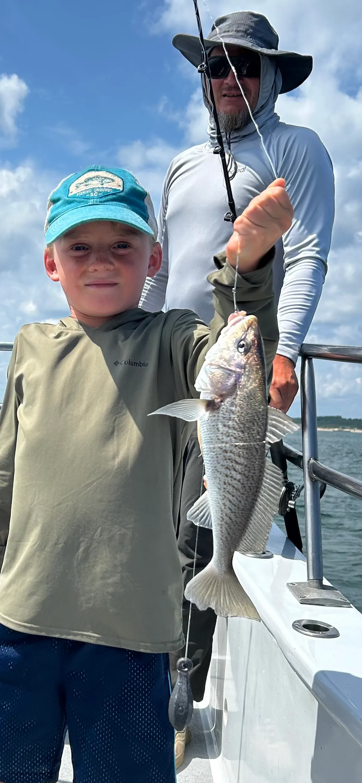Child catches a very big croaker
