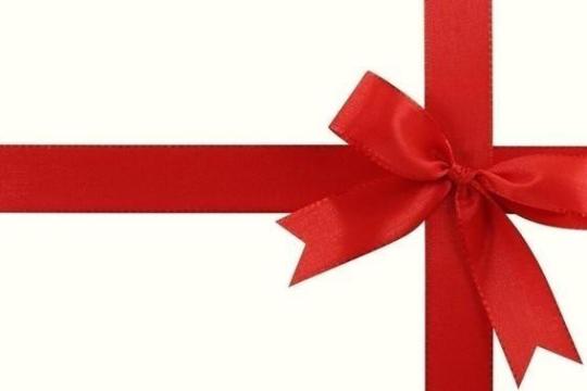 Red ribbon tied in a bow on a white background.